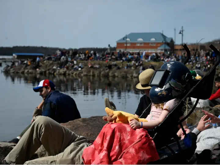 Eclipse watchers line the shore of Lake Champlain in Burlington, Vermont. Photo by Izzy Mitchell.