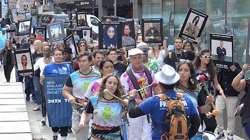 Shows the advocates and exonerees who are marching for increased wrongful conviction compensation