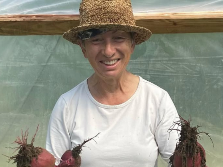 photo of Ipswich, Mass. farmer Shendel Bakal holding up some beets