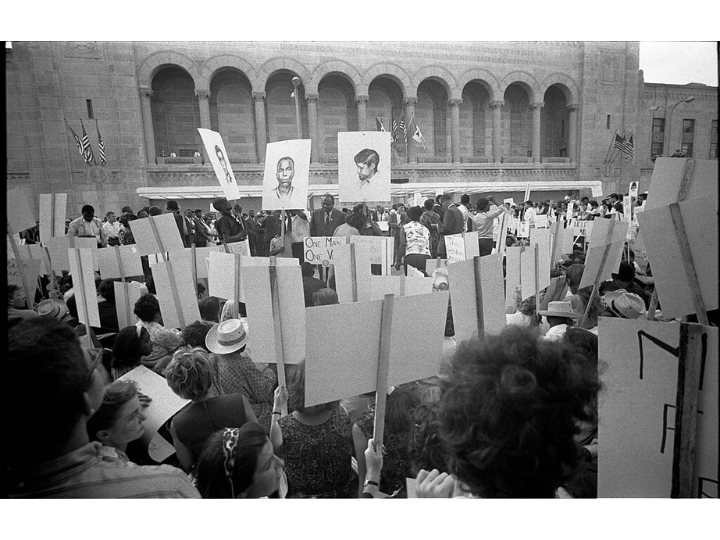 African American and white Mississippi Freedom Democratic Party supporters demonstrating outside the 1964 Democratic National Convention, Atlantic City, New Jersey; some hold signs with portraits of slain civil rights workers James Earl Chaney, Andrew Goodman, and Michael Schwerner.