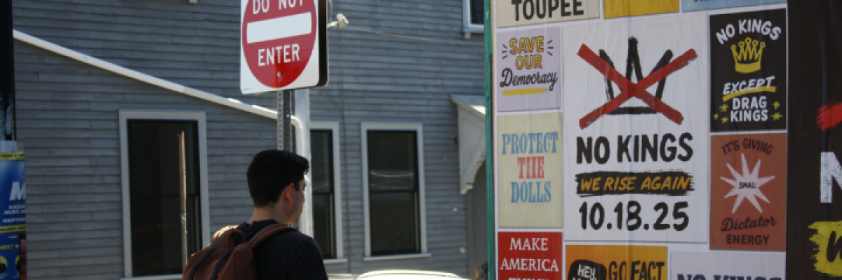 Someone walks past anti-ICE signage by Somerville Avenue in Somerville, MA, Oct. 5, 2025. Photo by Christopher Morris. Copyright 2025 Christopher Morris.
