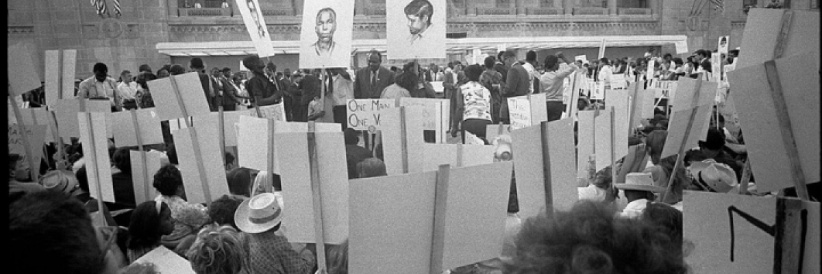 African American and white Mississippi Freedom Democratic Party supporters demonstrating outside the 1964 Democratic National Convention, Atlantic City, New Jersey; some hold signs with portraits of slain civil rights workers James Earl Chaney, Andrew Goodman, and Michael Schwerner.